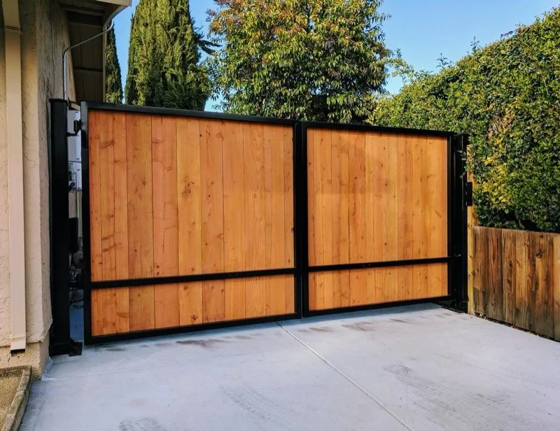 Custom cedar-and-iron driveway gate built by The Fence Guys