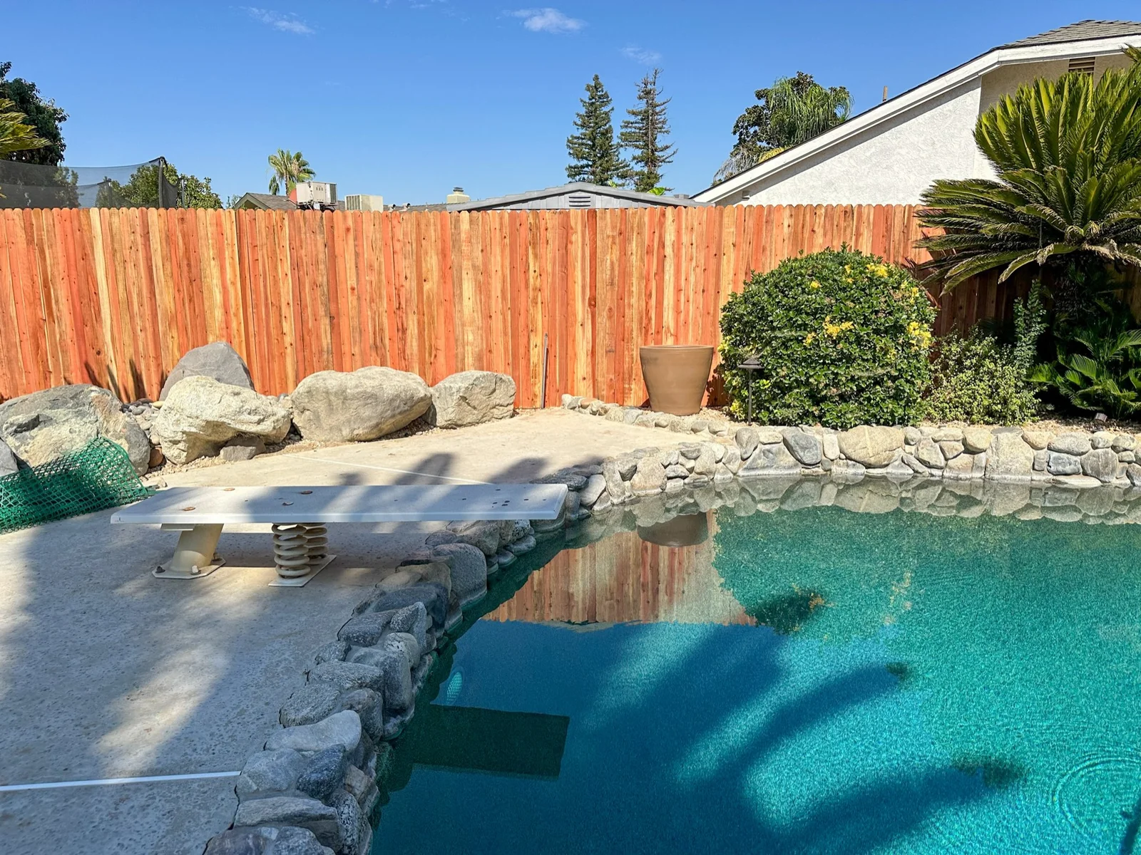 New redwood privacy fence around a Bakersfield backyard pool