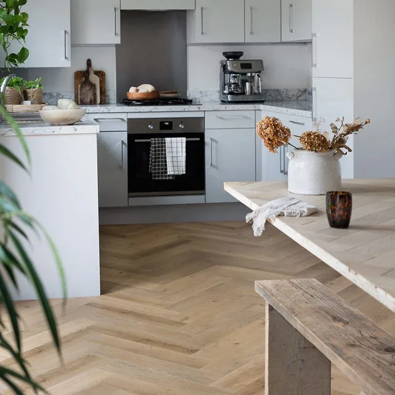 Kitchen with herringbone vinyl plank flooring