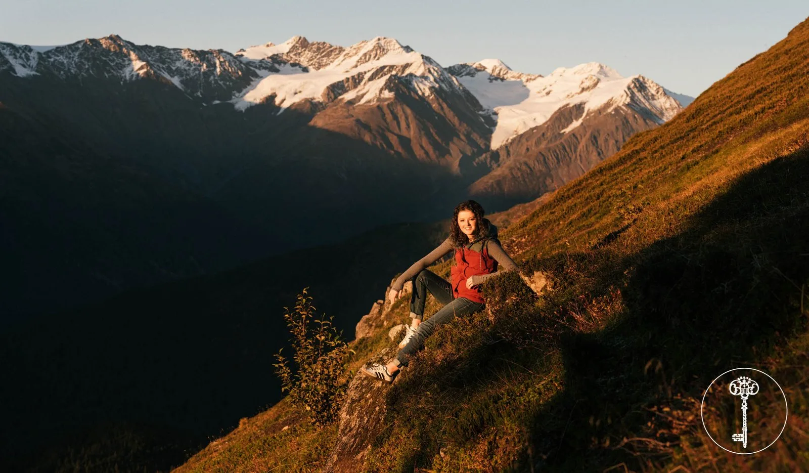 Senior portrait on an Alaskan mountainside at golden hour