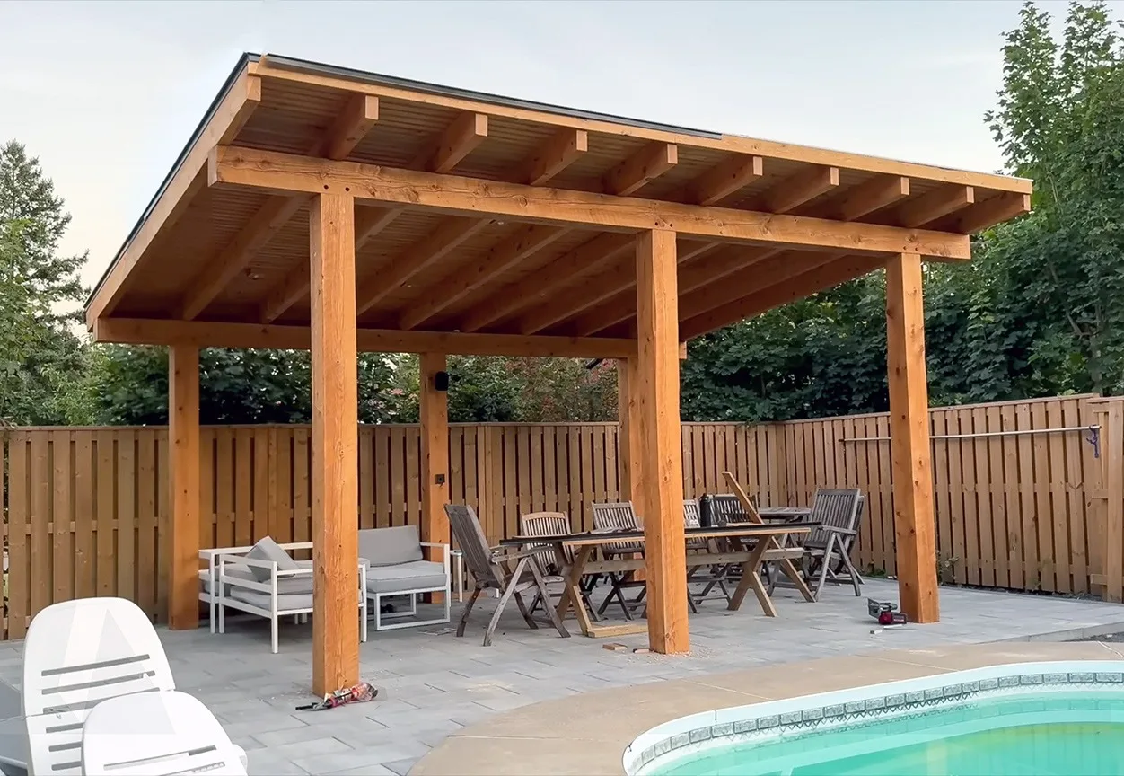 Finished cedar pergola beside a pool