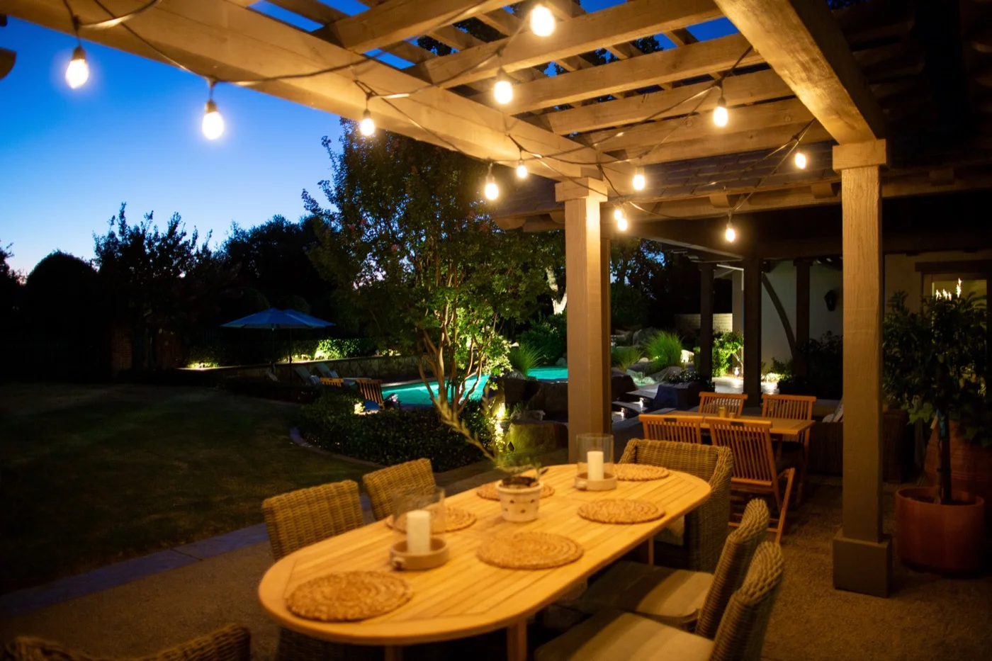 Bistro lighting over an outdoor dining and entertainment area